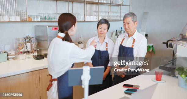 young manager scold elderly staffs - overworked waitress stock pictures, royalty-free photos & images