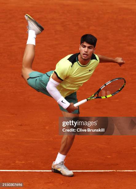 Carlos Alcaraz of Spain serves against Alexander Shevchenko of Kazakhstan during their 2nd Round match on Day Four of the Mutua Madrid Open at La...