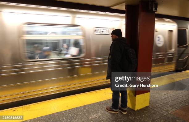 Person waits to board a train at the Herald Square subway station on April 23 in New York City.