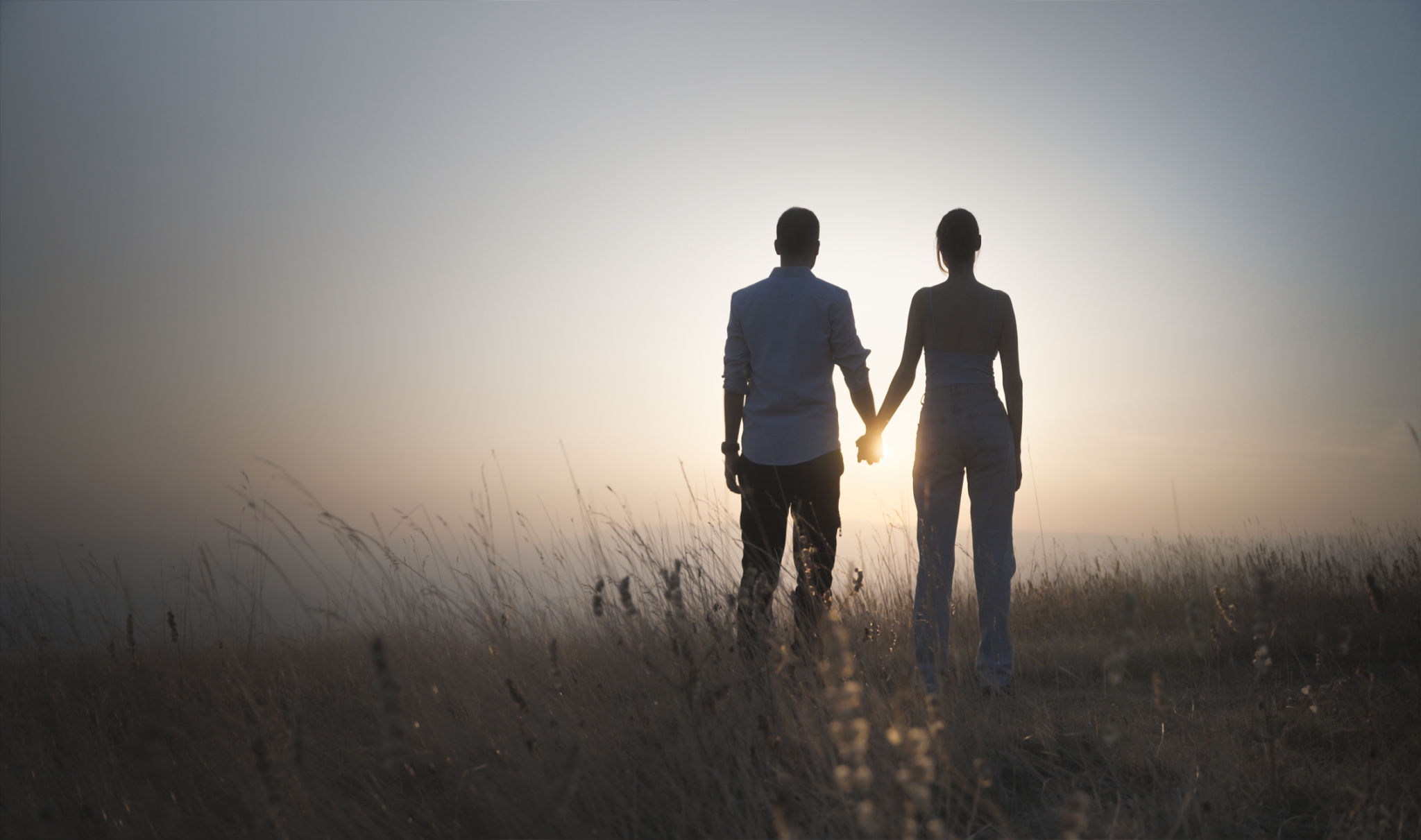 Couple in love holding hands in great outdoors Couple in love holding hands in great outdoors
