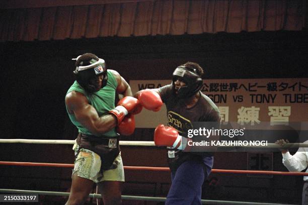 World heavyweight boxing champion Mike Tyson lands his right hook at his sparring partner Mark Willis during the public sparring session at Korakuen...
