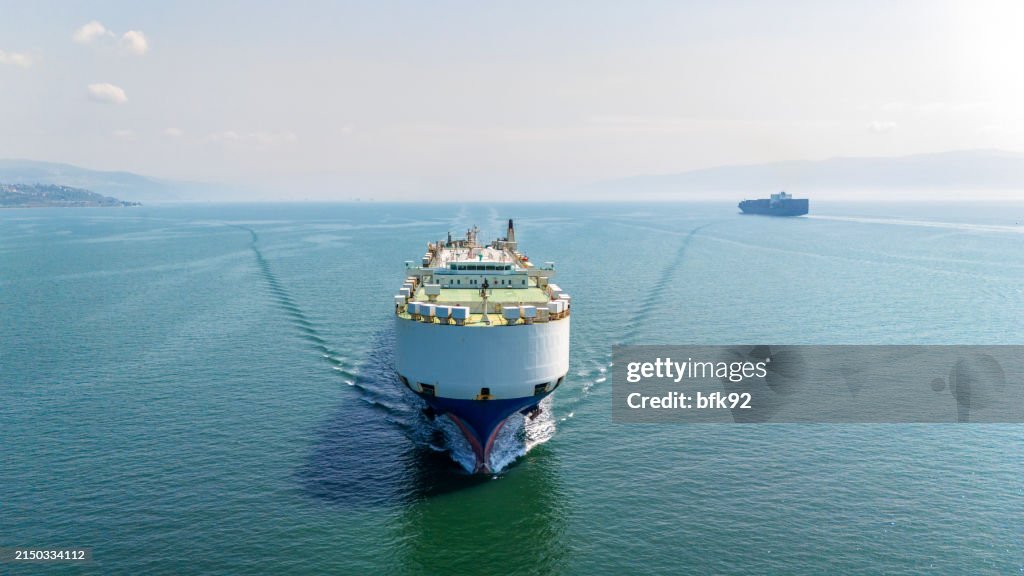 Aerial top view of Large Car Transporter ship or ocean going vehicle carrier ship in transit.