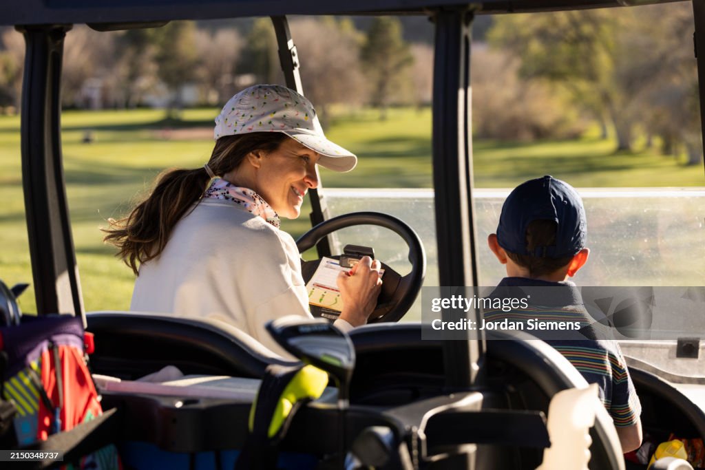 A mother and son golfing together.