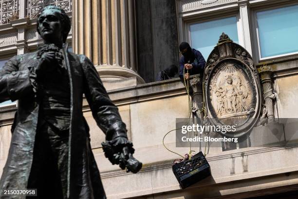Pro-Palestinian protestor lifts a milk crate with supplies while occupying Hamilton Hall at Columbia University in New York, US, on Tuesday, April...