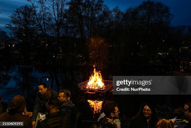 People are gathering by a bonfire during Walpurgis Night, a tradition meant to ward off evil spirits and celebrate the spring, in Linkoping, Sweden,...