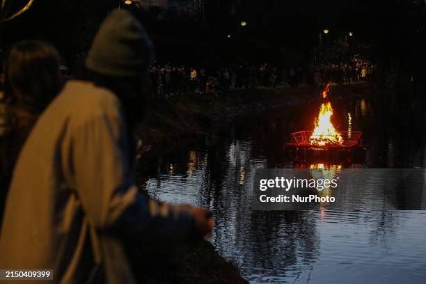 People are gathering by a bonfire during Walpurgis Night, a tradition meant to ward off evil spirits and celebrate the spring, in Linkoping, Sweden,...