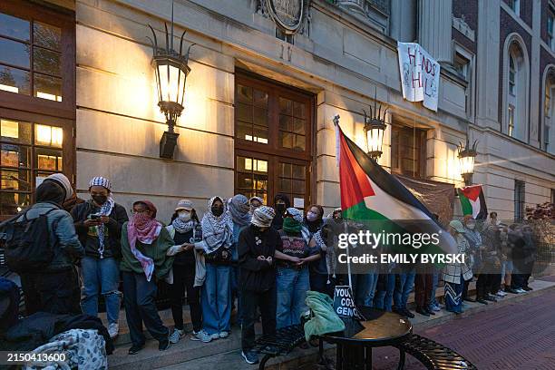Pro-Palestinian student protesters lock arms at the entrance to Hamilton Hall on the campus of Columbia University, on April 30 in New York City....