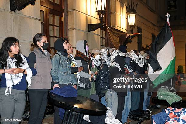 Pro-Palestinian student protesters lock arms at the entrance to Hamilton Hall on the campus of Columbia University, on April 30 in New York City....