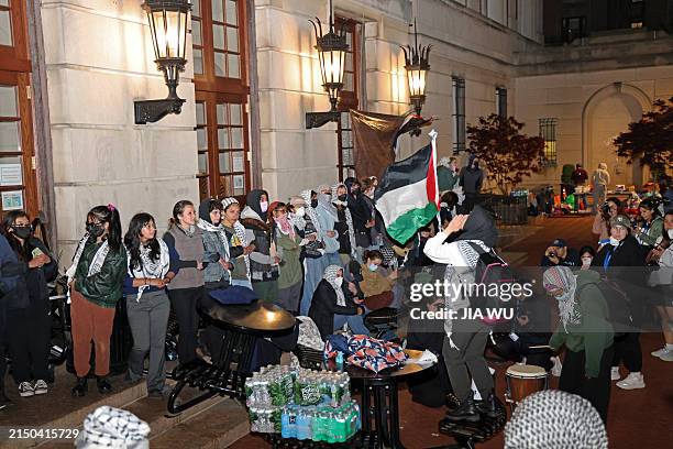 Pro-Palestinian student protesters lock arms at the entrance to Hamilton Hall on the campus of Columbia University, on April 30 in New York City....