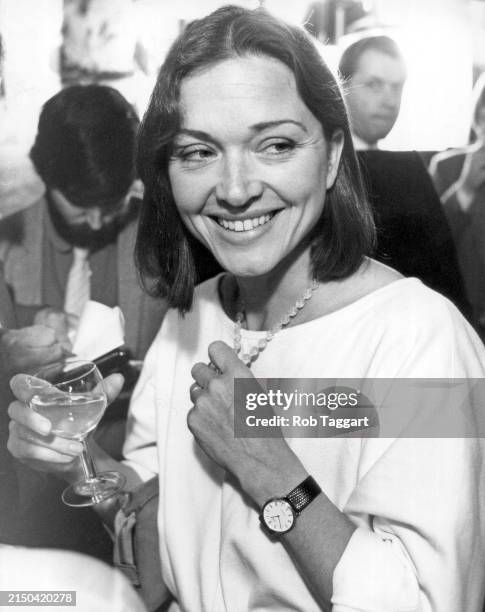 British Broadcaster and journalist Anna Ford enjoys a drink at a party in London, UK, on June 6, 1983.