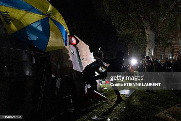 Counter protester attacks a pro-Palestinian demonstrator as clashes erupt at a pro-Palestinian encampment set up on the campus of the University of...