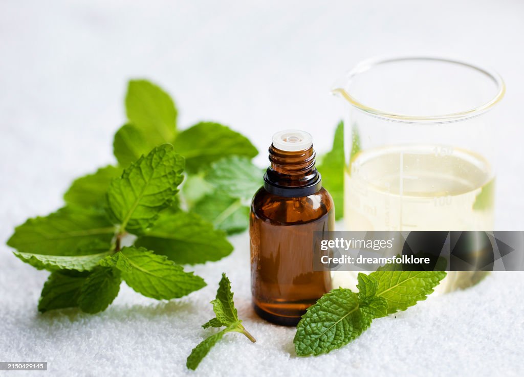 Peppermint Essential Aromatherapy oil on white background
