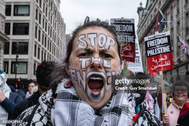 Woman with Stop The Genocide painted on her face during a Pro-Palestinian Rally on April 27, 2024 in London, England. Protesters demand that the UK...