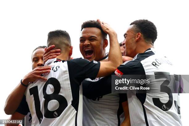 Rodrigo Muniz of Fulham celebrates scoring his team's first goal with teammates Andreas Pereira and Antonee Robinson during the Premier League match...