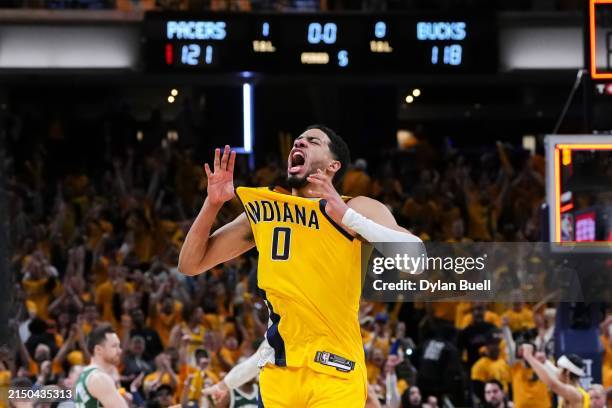 Tyrese Haliburton of the Indiana Pacers celebrates after beating the Milwaukee Bucks 121-118 in overtime to win game three of the Eastern Conference...