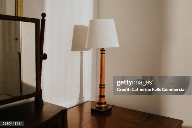 simple image of a lamp in a sunny bedroom - lamp shade stock pictures, royalty-free photos & images