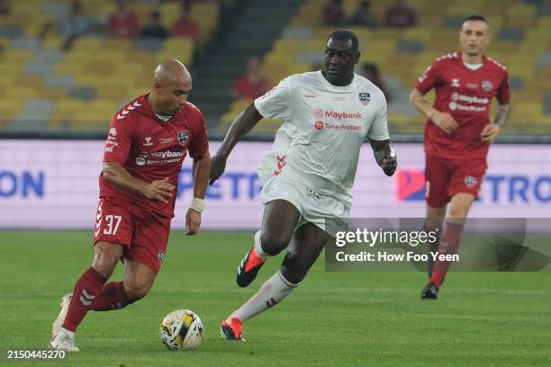 Danny Webber of Manchester Reds and Emile Heskey of Liverpool Reds in action during the Battle of the Reds at the Bukit Jalil National Stadium on...