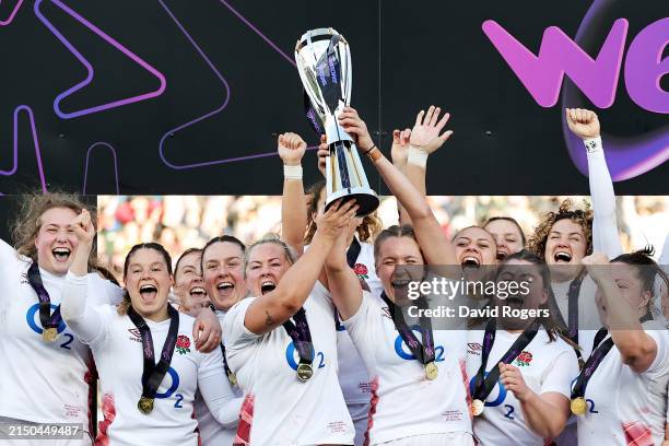 Marlie Packer and Zoe Aldcroft of England lift the Six Nations trophy after their team’s victory during the Guinness Women's Six Nations 2024 match...