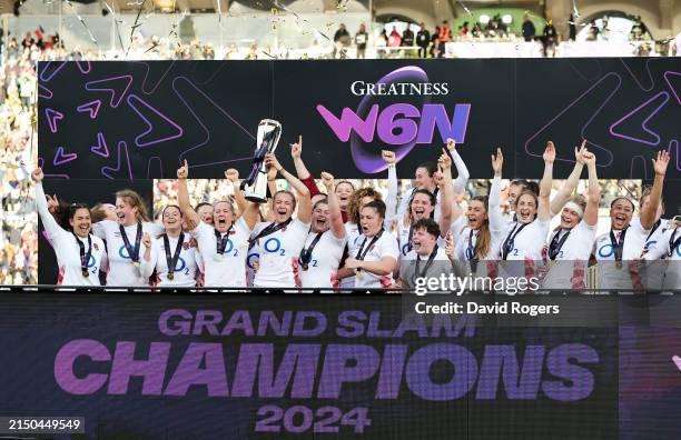 Marlie Packer and Zoe Aldcroft of England lift the Six Nations trophy after their team’s victory during the Guinness Women's Six Nations 2024 match...