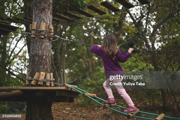 little girl climbing adventure park. - obstacle course stock pictures, royalty-free photos & images