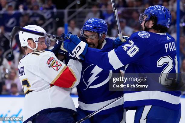 Aleksander Barkov of the Florida Panthers and Matt Dumba of the Tampa Bay Lightning tussle during the first period during Game Four of the First...