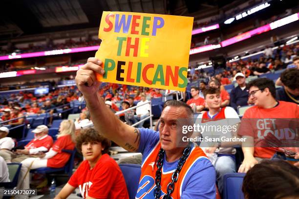 Thunder fan holds up a sign that reads "Sweep the Pelicans" during the fourth quarter in Game Three of the first round of the 2024 NBA Playoffs...