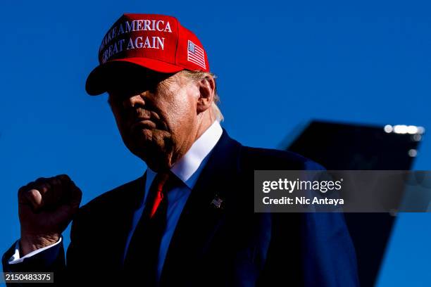 Republican presidential candidate, former U.S. President Donald Trump holds a fist up during a rally on May 1, 2024 at Avflight Saginaw in Freeland,...