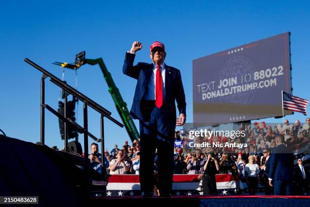 Republican presidential candidate, former U.S. President Donald Trump holds up a fist during a rally on May 1, 2024 at Avflight Saginaw in Freeland,...