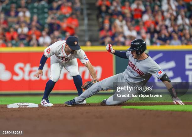 Houston Astros second base Jose Altuve tags Cleveland Guardians catcher David Fry in the top of the second inning during the MLB game between the...