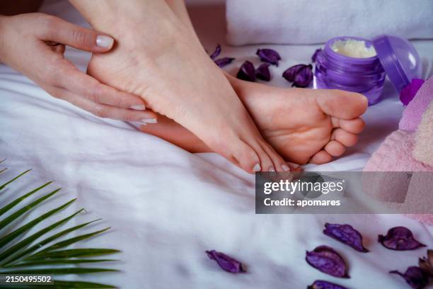 hispanische junge frau befeuchtet füße mit natürlichem aloe-vera-gel - aloe vera gel stock-fotos und bilder
