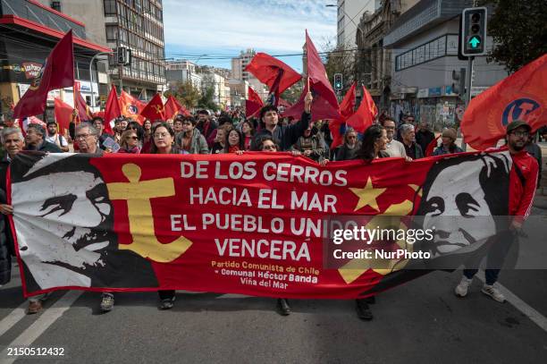 People are holding a banner of the communist party while marching for International Workers' Day in Valparaiso, Chile, on May 1, 2024.