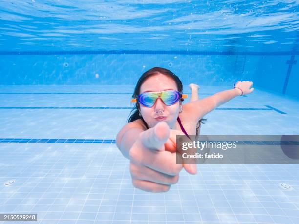 little girl having fun swimming underwater - kid reaction portrait stock pictures, royalty-free photos & images