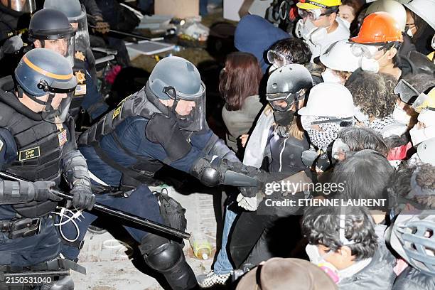 Police make an arrest as they face-off with pro-Palestinian students after destroying part of the encampment barricade on the campus of the...