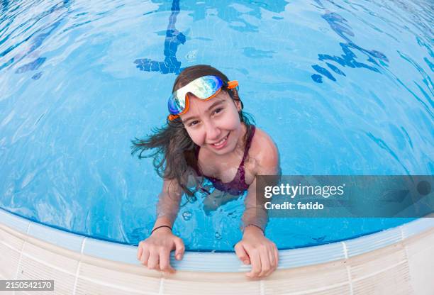 girl in swim goggles looking at camera at poolside - kid reaction portrait stock pictures, royalty-free photos & images