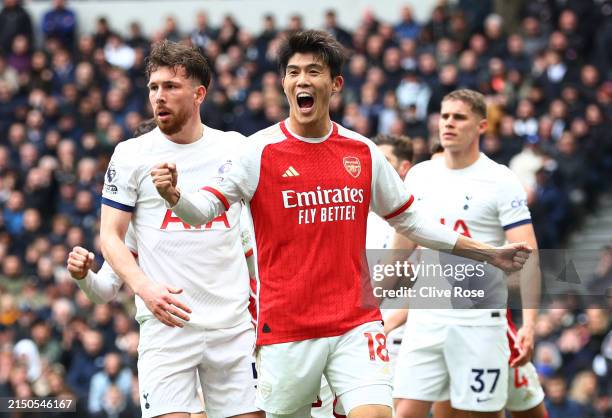 Takehiro Tomiyasu of Arsenal celebrates after Pierre-Emile Hojbjerg of Tottenham Hotspur scored an own goal, Arsenal's first goal during the Premier...