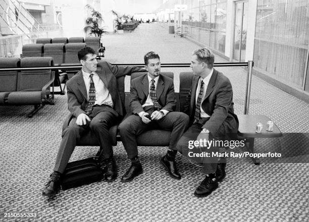 Australia cricketers Matthew Elliott, Ricky Ponting and Shane Warne waiting for their flight before departing for the Ashes tour of England, in...