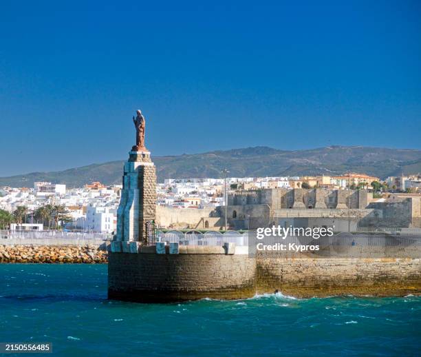 lighthouse or statue - tarifa stock pictures, royalty-free photos & images