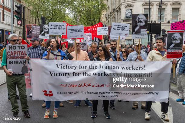 Supporters of Solidarity with the Iranian Worker's movement committee take part in a May Day march organised by the London May Day Organising...