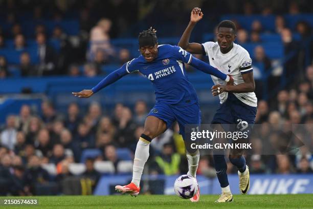 Chelsea's English midfielder Noni Madueke vies with Tottenham Hotspur's Senegalese midfielder Pape Matar Sarr during the English Premier League...