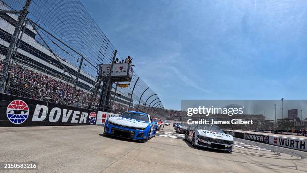 Kyle Busch, driver of the FICO Chevrolet, and Ryan Blaney, driver of the Wurth Ford, lead the field on a pace lap prior to the NASCAR Cup Series...