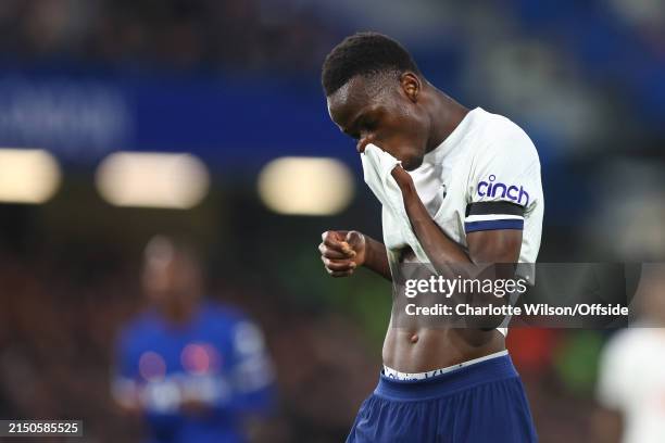 Pape Matar Sarr of Tottenham Hotspur wipes his face with his shirt during the Premier League match between Chelsea FC and Tottenham Hotspur at...