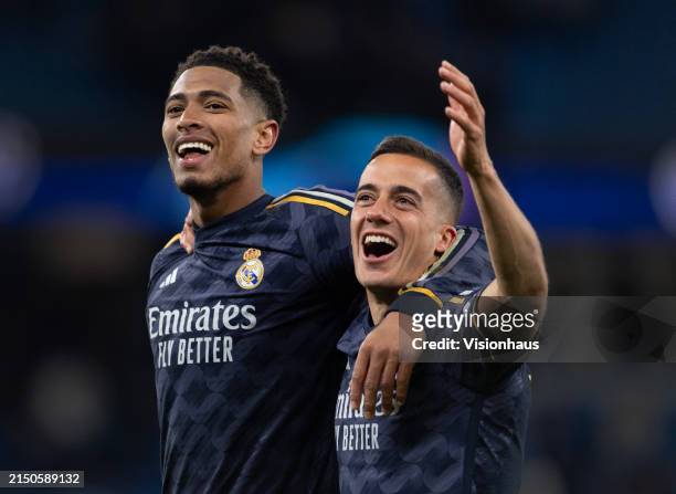 Jude Bellingham and Lucas Vazquez of Real Madrid CF celebrate after the UEFA Champions League quarter-final second leg match between Manchester City...