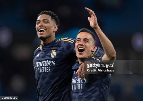 Jude Bellingham and Lucas Vazquez of Real Madrid CF celebrate after the UEFA Champions League quarter-final second leg match between Manchester City...