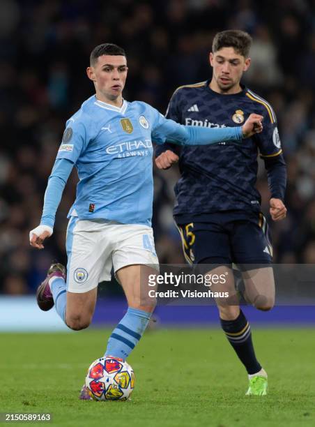 Phil Foden of Manchester City and Federico Valverde of Real Madrid CF in action during the UEFA Champions League quarter-final second leg match...