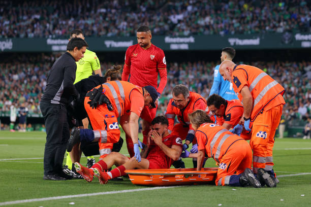 Isaac Romero of Sevilla FC reacts before being stretched off after suffering an injury during the LaLiga EA Sports match between Real Betis and...