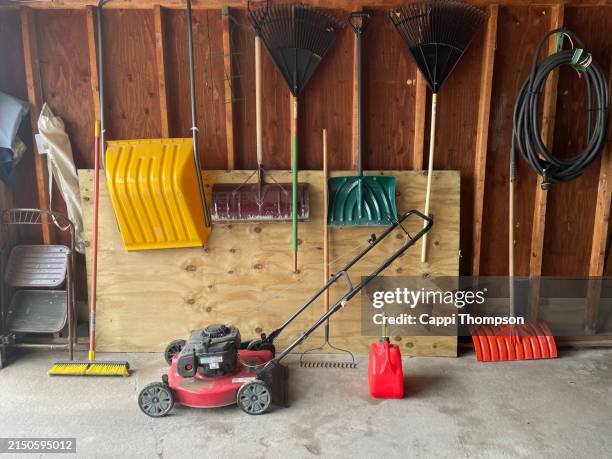 spring tools and lawn mower in garage - shed stock pictures, royalty-free photos & images