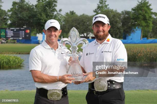 Rory McIlroy of Northern Ireland and Shane Lowry of Ireland pose with the trophy after the final round of the Zurich Classic of New Orleans at TPC...