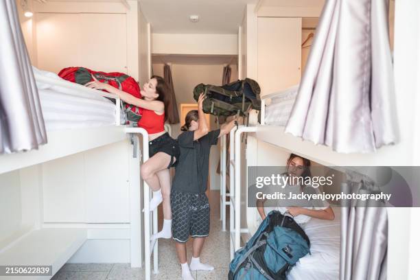 conversation between roommates in the hostel's bedroom - bunk bed stock pictures, royalty-free photos & images