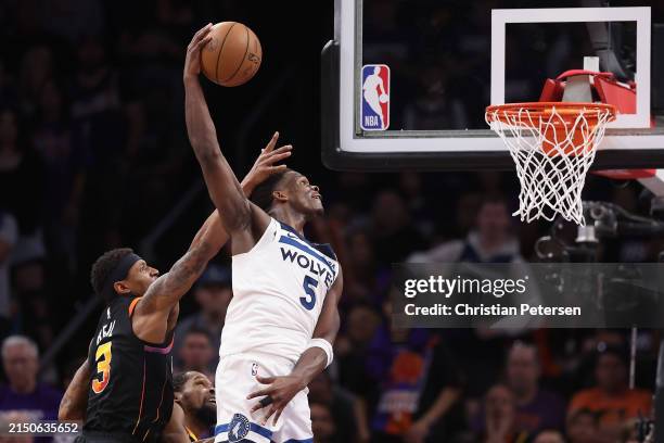Anthony Edwards of the Minnesota Timberwolves slam dunks the ball ahead of Bradley Beal of the Phoenix Suns during the second half of game four of...