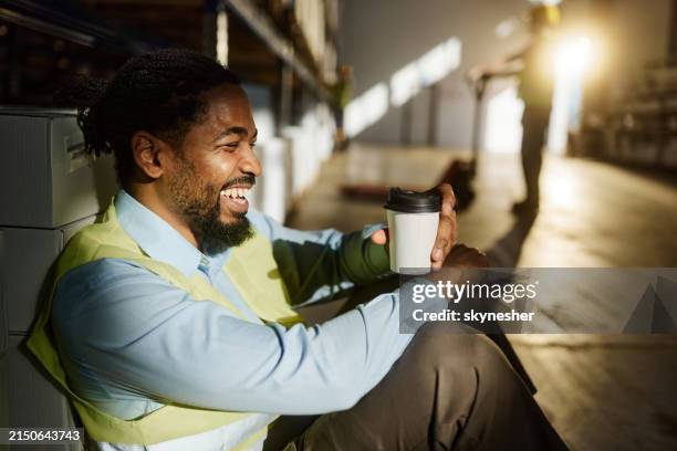 happy black manager having a break in distribution warehouse. - coffee break stock pictures, royalty-free photos & images